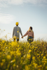 Wall Mural - loving couple in meadow admiring the view