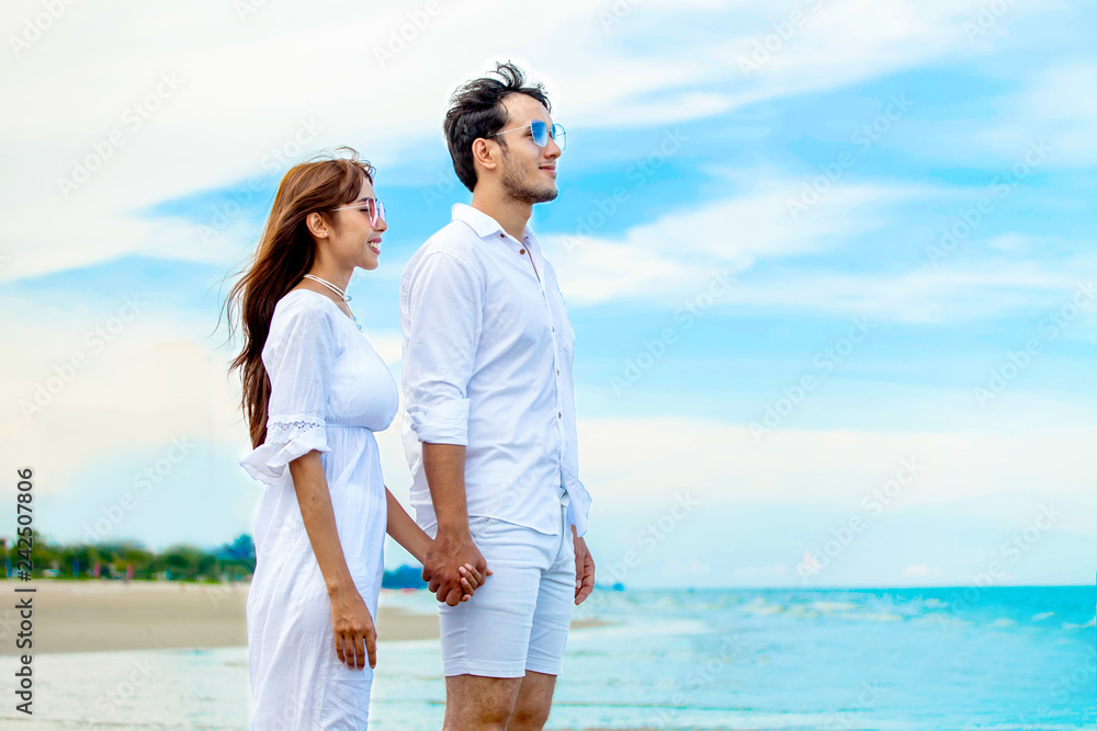 Photo Stock Young couple in love looking the future and holding hand  together at sea beach on blue sky .happy smiling young wedding with white  dress romantic moment | Adobe Stock