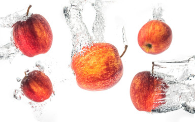 Wall Mural - Apples falling under water with a splash. Background