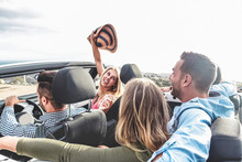 Happy Friends With Hands Up Having Fun In Convertible Car On Summer Vacation
