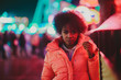 © ADDICTIVE STOCK - Black woman standing on night city street
