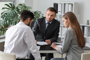 Wall Mural - Unhappy young couple visiting divorce lawyer in office