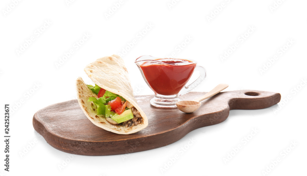 Board with tasty taco and sauce on white background
