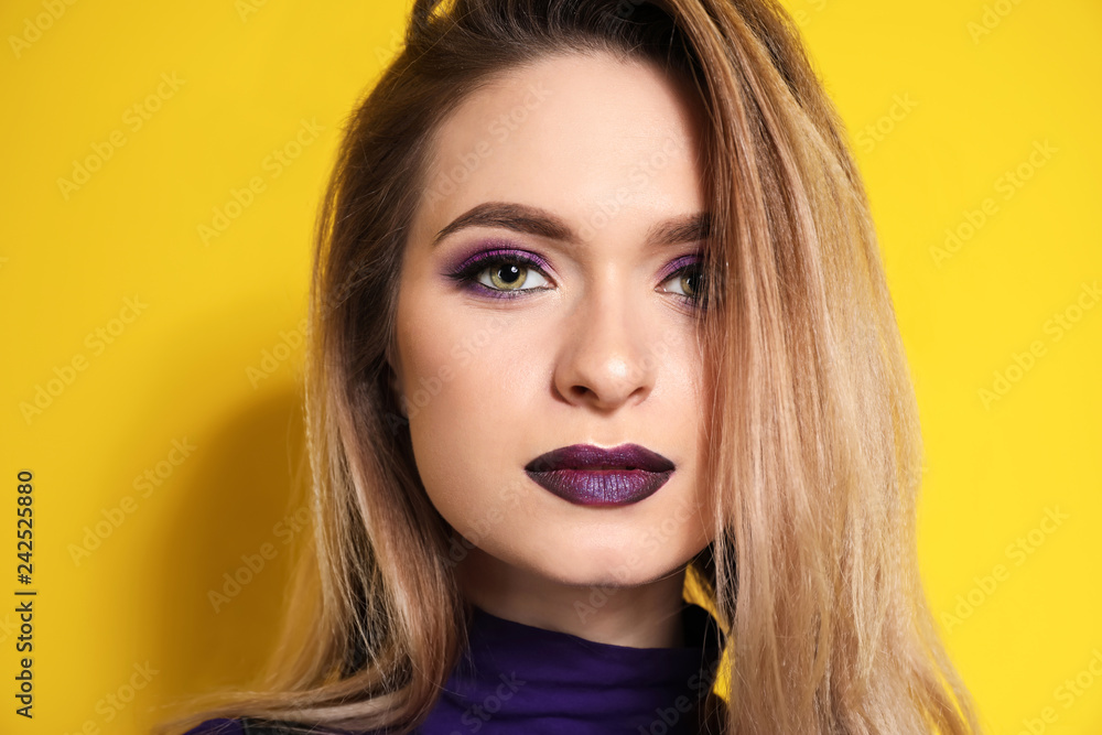 Fashionable young woman on color background