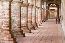 Photograph Of An Old Arched Brick Walkway With Brick Pillars