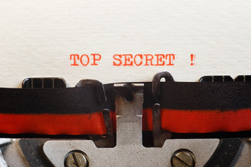 Top secret. The text is typed on a vintage typewriter, close up.