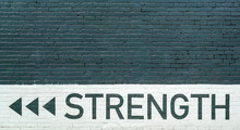Gray Brick Wall Vith Strength Motto