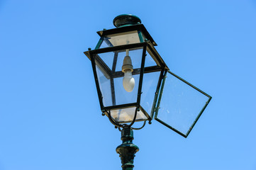 Isolated old vintage lamppost against a blue sky in Lisbon, Portugal