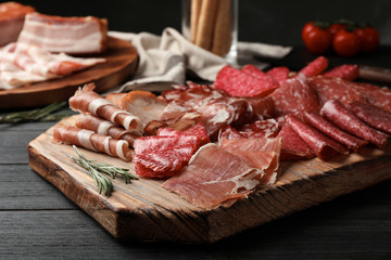 Cutting board with different sliced meat products served on table