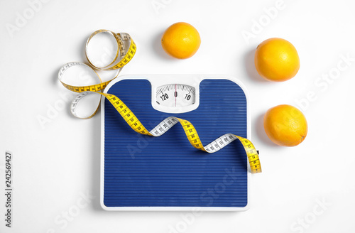 Fotografie, Obraz Composition with scales, oranges and tape measure on white background, top view