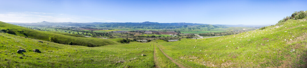 Wall Mural - Trail through the verdant hills of south San Francisco bay area, panoramic view towards Coyote Valley, Santa Cruz mountains in the background, San Jose, California