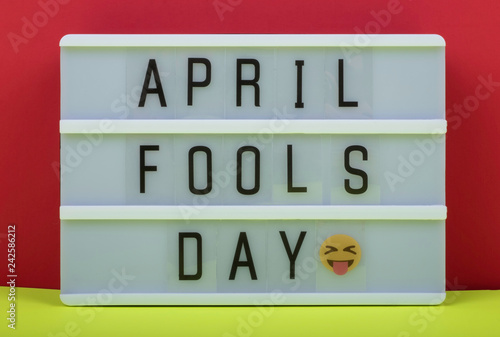 Fotografie, Obraz April Fool's day lettering on Lightbox on Red and Yellow background