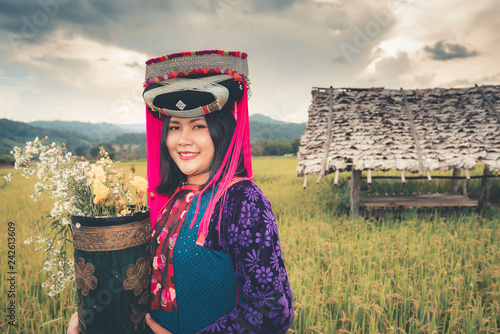 Plakat Portrait of woman tribal Lisu in traditional dress and jewelry costume in rice fields., Lifestyle of hill tribe girl in the north of Thailand.,Cultural outdoor portrait.
