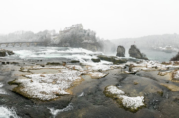 Poster - Rhine Falls in Switzerland on a winter day with snow falling