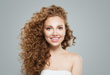 Happy redhead woman with long healthy curly hair. Cute female face