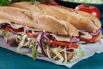 Poster - Submarine sandwiches with ham, cheese and vegetables