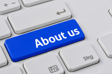 Wall Mural - a keyboard with a blue button - about us