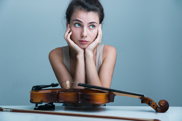 Portrait of a beautiful young woman sitting at the table