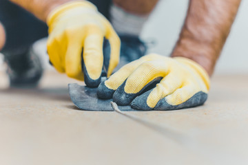 Master cuts off the excess welding cord - Quarter moon spatula trimming knife for vinyl floor welding - heat weld vinyl installation