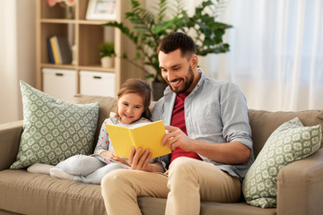 Poster - family, leisure and people concept - happy father and daughter reading book at home