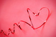 Beautiful luxury red heart shape from wire ribbon on red background and small heart use for valentines ‘s day concept.