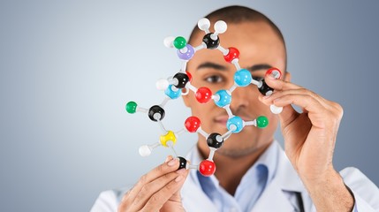 Wall Mural - Close up of Molecular structure model in hand on background
