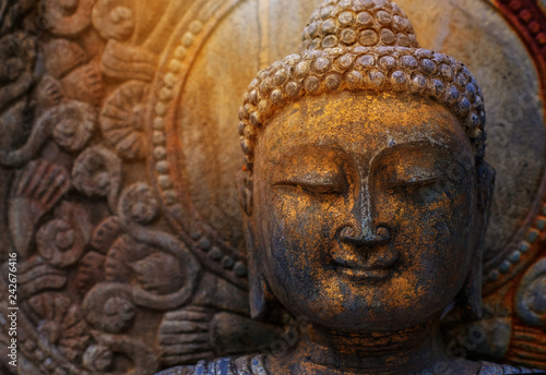 Fotomural Rock Buddha statue with sunlight used for amulets of Buddhism religion