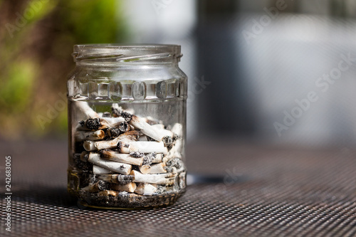 Fotografija Jar full with smoked cigarette filters