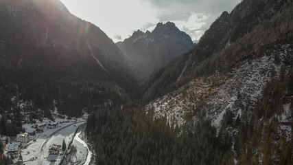 Wall Mural - Aerial panoramic view of mountain valley in winter with snow, forest and river