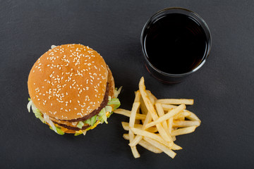 Delicious junk food: burger, fries, coca-cola