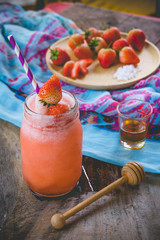 Wall Mural - Strawberry smoothie juice ,  on topping honey tasty for summer on wood table , sweet water juice for health