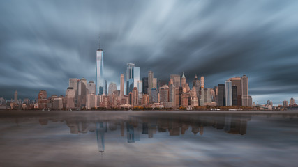 Wall Mural - New York City Manhattan downtown skyline in evening with stormy sky