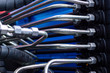 © ilyaplatonov - Close up of pipe system of hydraulic valves in agricultural machinery