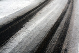 Fototapeta Do przedpokoju - Car tracks on snowy road.