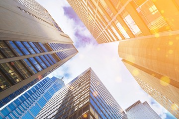 Modern office glass buildings over sky background