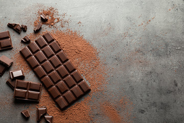 Wall Mural - Flat lay composition with tasty chocolate on grey background. Space for text