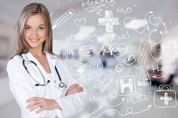 Wall Mural - Attractive young female doctor with blurred hospital interior on