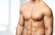 © BillionPhotos.com - Close up of perfect male body isolated on black background with