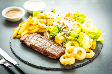 Sticker - Grilled beef meat steak with french fries onion ring with sauce and fresh vegetable