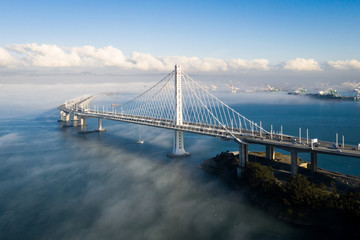 san francisco - oakland bay bridge east span with low fog in background