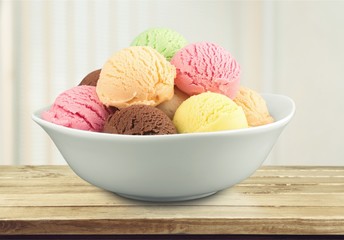 Wall Mural - Ice cream scoops in bowl on white background