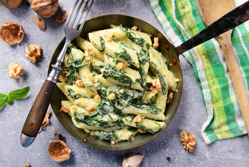 Wall Mural - Penne pasta with spinach, gorgonzola cheese and walnuts