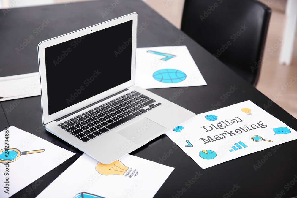 Laptop on dark table in modern office