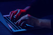 © Pixel-Shot - Professional hacker with laptop sitting at table, closeup