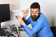 © Volodymyr - Working with passion. Assemblying of electronic devices. Bearded man repair circuit board. Engineer or technician at work. Bearded hipster works on fixing digital hardware. New technology and tech