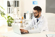© Pixel-Shot - Male doctor working on laptop in clinic