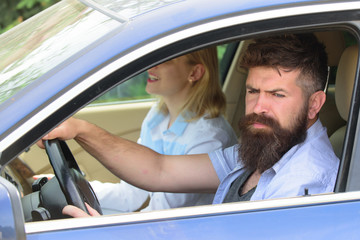 Wall Mural - Ecology and environment. Bearded man and sexy woman driving car. Loving couple enjoy sustainable travel. Couple in love travel by automobile transport. Using sustainable transport for zero pollution