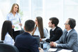 © yurolaitsalbert - business woman conducting a presentation for business colleagues