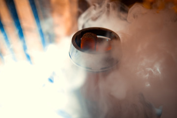 hot red coals for Shisha warmed up on the stove in a hookah bar