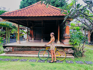 Wall Mural - Beautiful woman sitting with retro bicycle.